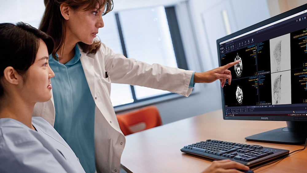 A radiologist pointing to a screen