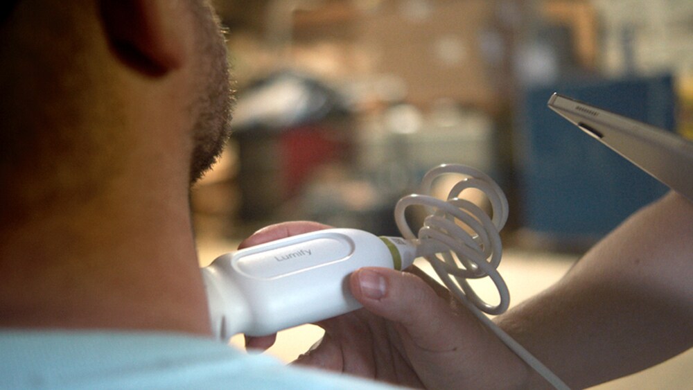 A nurse conducting a mobile ultrasound scan on a patient