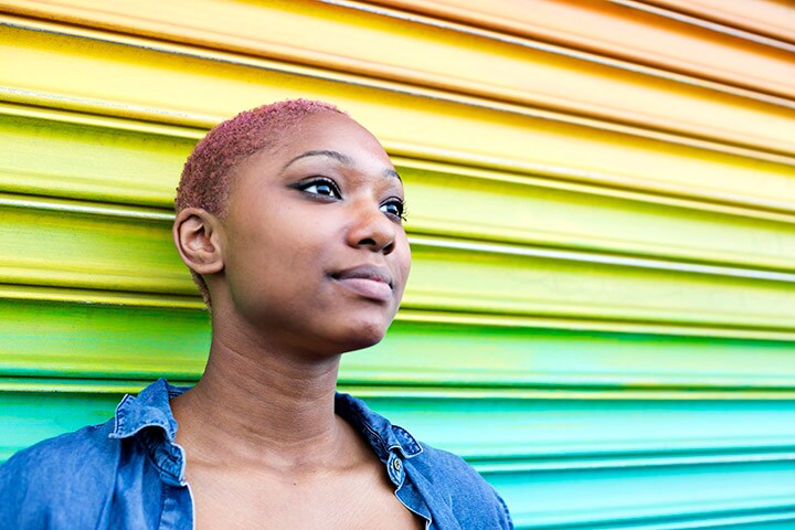 Woman standing in front of a rainbow 